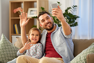 Image showing father and daughter taking selfie at home