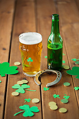 Image showing glass of beer, bottle, horseshoe and gold coins