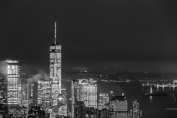 Image showing New York City skyline with lower Manhattan skyscrapers in storm at night.