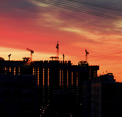 Image showing Cranes and Construction Equipment on Sunrise