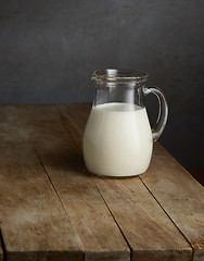 Image showing milk jug on wooden table