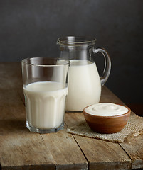 Image showing milk and sour cream on wooden table