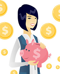 Image showing Young asian business woman holding a piggy bank.