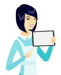 Image showing Young asian cleaner holding tablet computer.