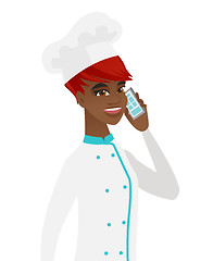 Image showing African-american chef talking on a mobile phone.