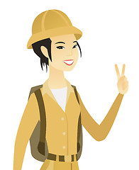 Image showing Young asian traveler showing victory gesture.