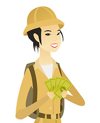 Image showing Young asian traveler holding money.