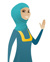 Image showing Young muslim business woman waving her hand.