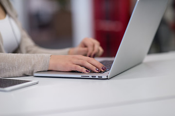 Image showing businesswoman using a laptop in startup office