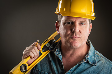 Image showing Serious Contractor in Hard Hat Holding Level and Pencil With Dra