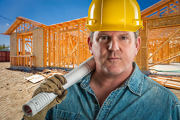 Image showing Serious Contractor in Hard Hat Holding Floor Plans At Constructi