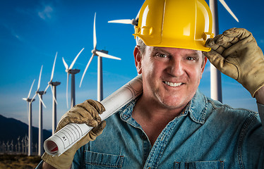 Image showing Smiling Contractor in Hard Hat Holding Extention Cord Outdoors N