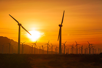 Image showing Silhouetted Wind Turbines Over Dramatic Sunset Sky