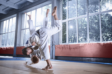 Image showing Two judo fighters showing technical skill while practicing martial arts in a fight club