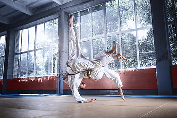 Image showing Two judo fighters showing technical skill while practicing martial arts in a fight club