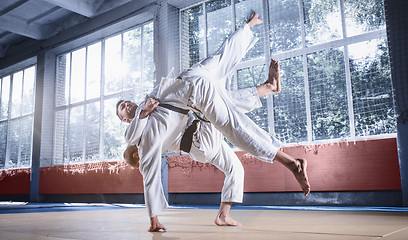 Image showing Two judo fighters showing technical skill while practicing martial arts in a fight club