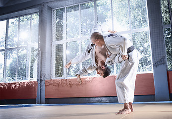 Image showing Two judo fighters showing technical skill while practicing martial arts in a fight club