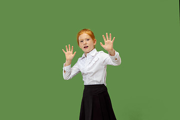 Image showing Portrait of the scared teen girl on green