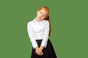 Image showing Beautiful teen girl looking suprised and bewildered isolated on green