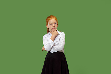 Image showing Young serious thoughtful teen girl. Doubt concept.