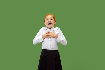 Image showing Beautiful teen girl looking suprised isolated on green