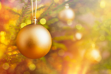 Image showing Christmas-tree decoration bauble on decorated Christmas tree bac