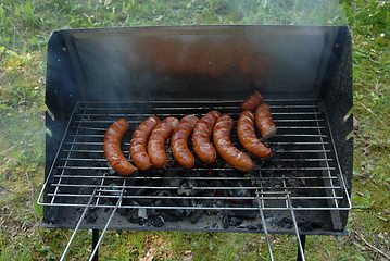 Image showing Sausages cooking on the grill