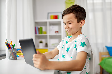 Image showing student boy with tablet pc and notebook at home