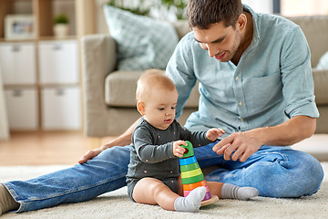 Image showing father playing with little baby daughter at home