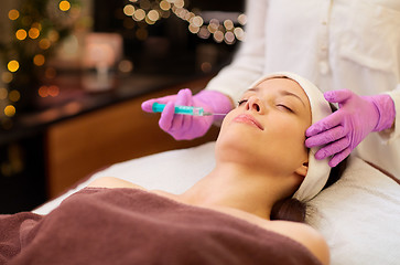 Image showing beautician doing beauty injection to woman lips