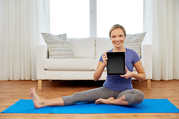 Image showing woman with tablet computer doing yoga at home