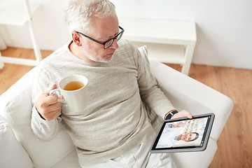 Image showing senior man having video chat with pharmacist