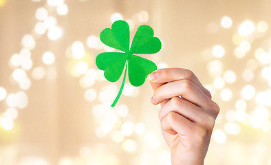 Image showing hand holding green paper four-leaf clover