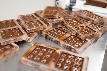 Image showing chocolate in candy molds at confectionery shop