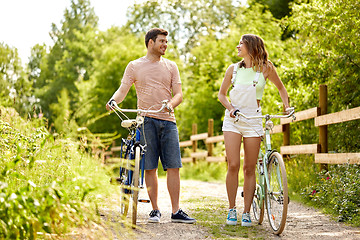 Image showing happy couple with bicycles at summer park