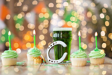 Image showing glass of beer, cupcakes, horseshoe and gold coins