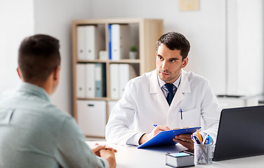 Image showing doctor with clipboard and male patient at hospital