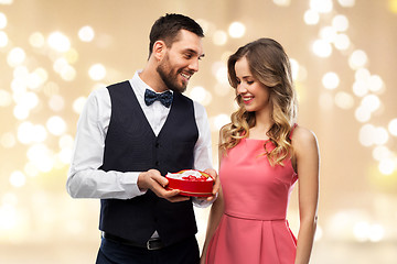 Image showing happy couple with chocolate box in shape of heart