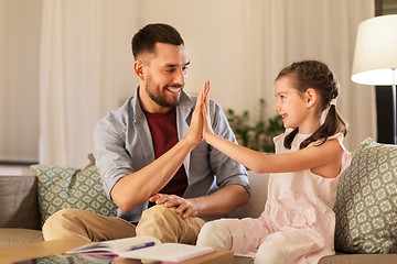 Image showing father and daughter doing homework together