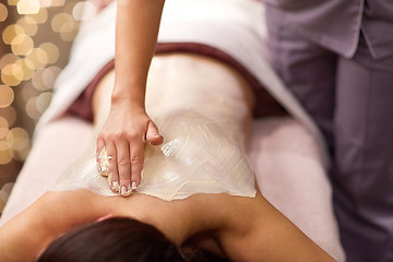 Image showing woman having back massage with cream at spa