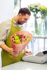 Image showing smiling florist man with bunch at flower shop