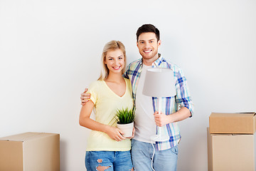 Image showing couple with flower and lamp moving to new home