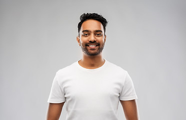 Image showing smiling young indian man over gray background