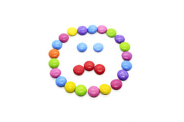 Image showing Smiley from multicolored chocolate glazed candies on white