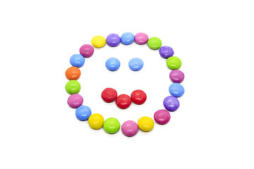 Image showing Smiley from multicolored chocolate glazed candies on white