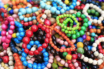 Image showing Colorful handmade wooden bracelets, close-up background