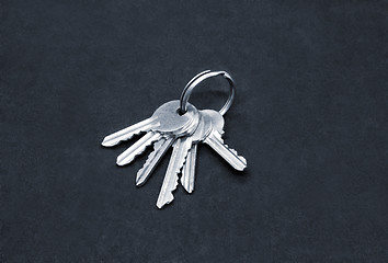 Image showing Many silver keys on the ring on dark background