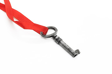 Image showing Vintage silver key on red ribbon on white background