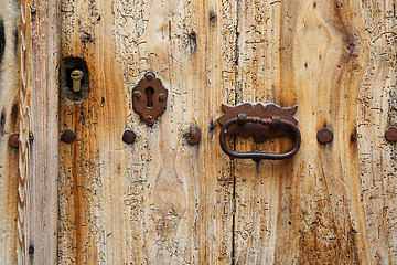 Image showing Texture of ancient wooden door with keyholes and handle