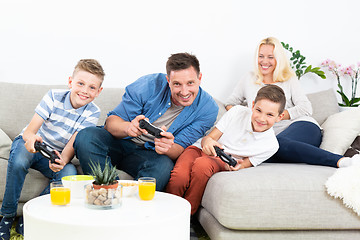 Image showing Happy young family playing videogame On TV.